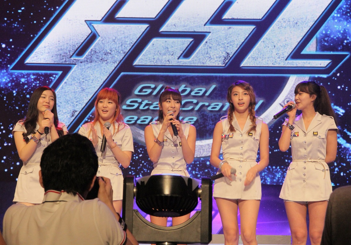young K-pop group performing with vibrant energy