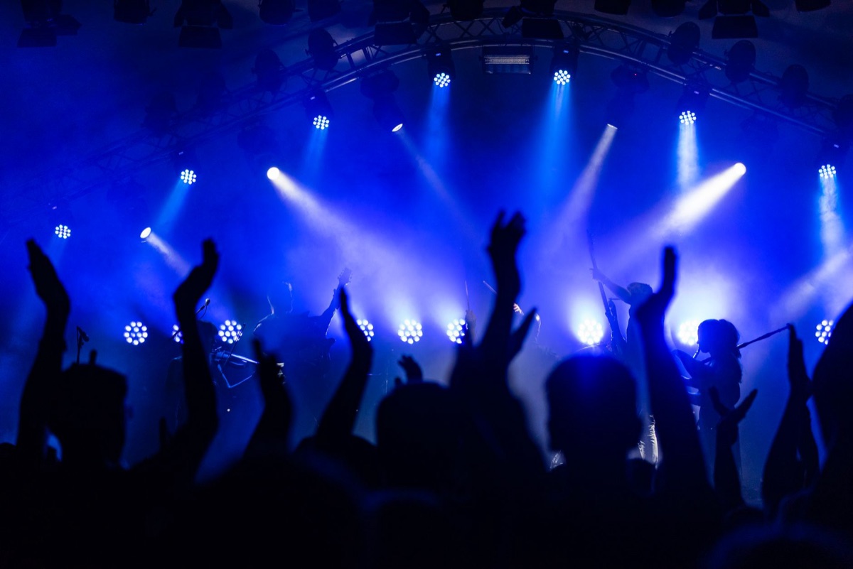 K-POP STAR in front of crowd with flashing lights
