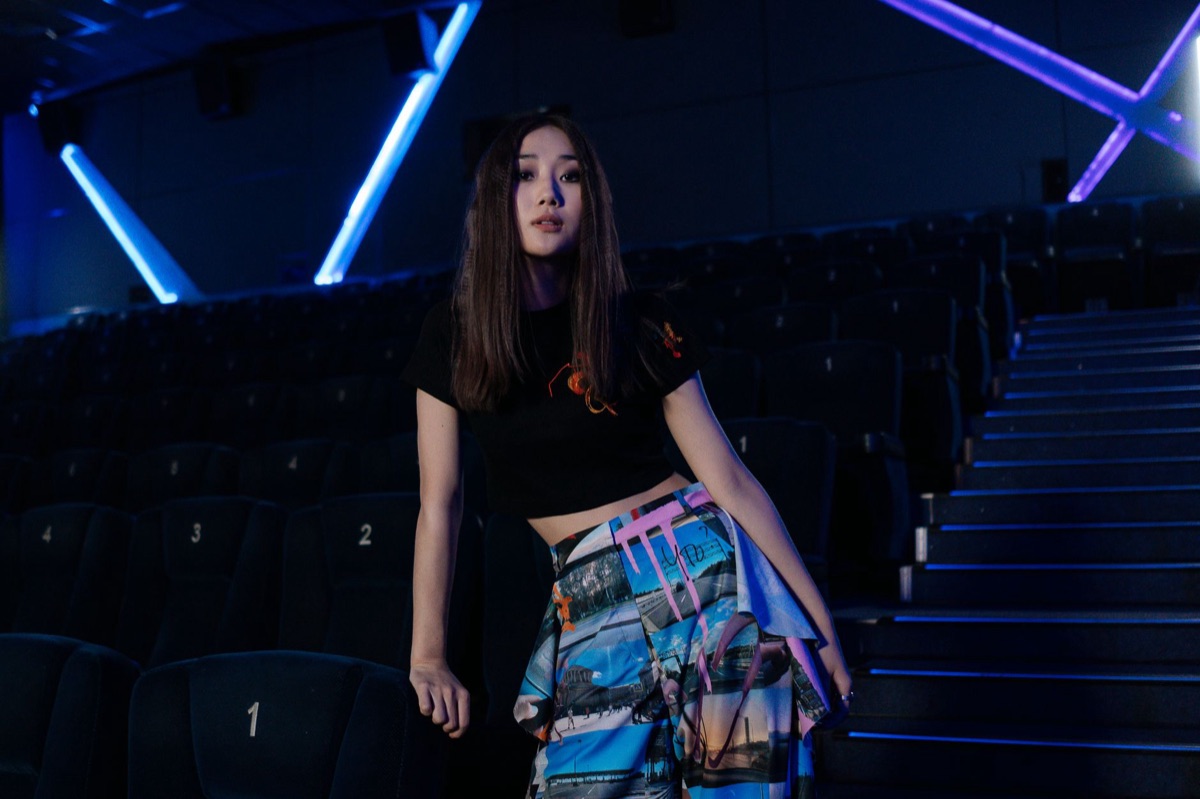K-pop star in studio, wearing debut outfit