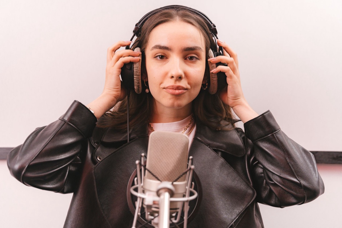 K-pop star holding microphone in studio