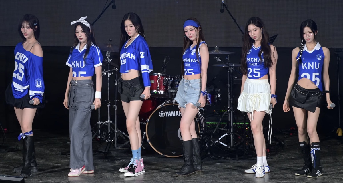 K-POP group members on stage with audience